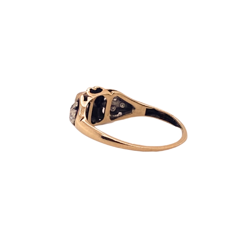 a gold ring with black diamonds on it
