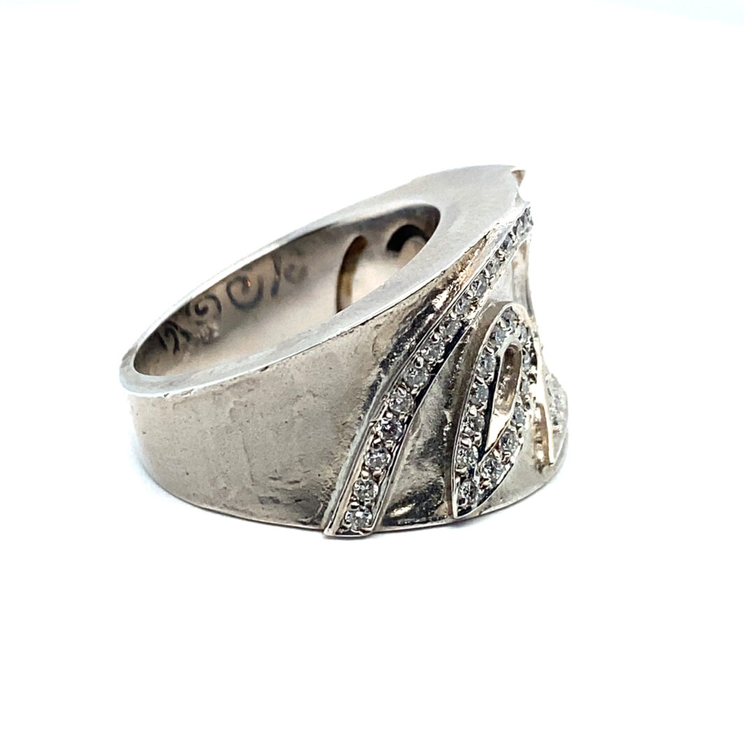 a silver ring with diamonds on it
