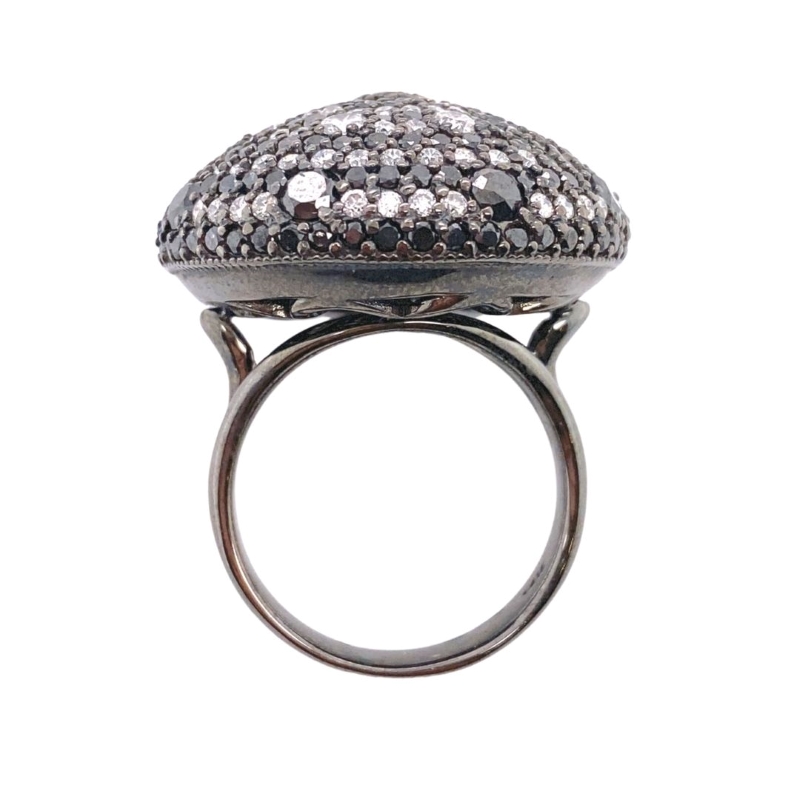 a silver ring with black and white stones