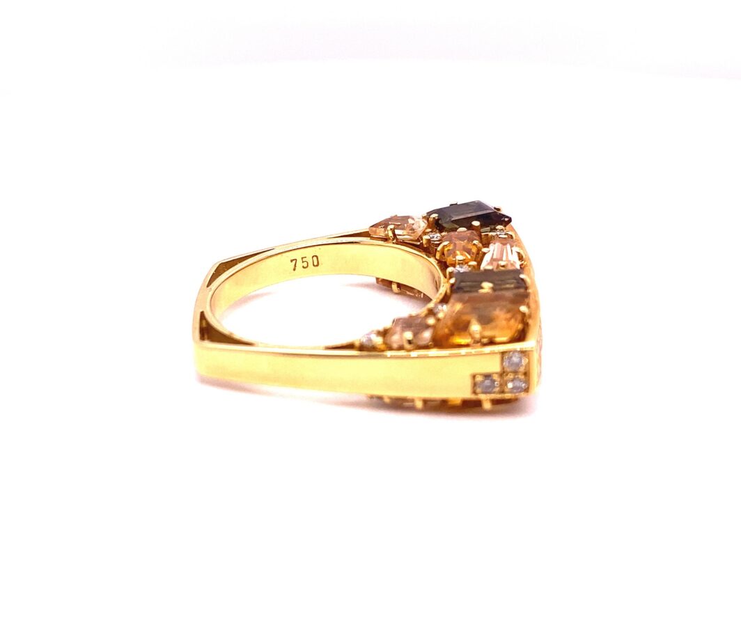 a yellow gold ring with brown and white diamonds