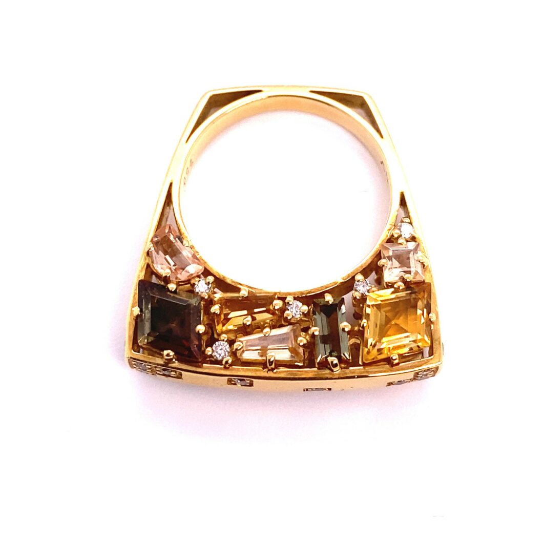 a gold ring with different colored stones on it
