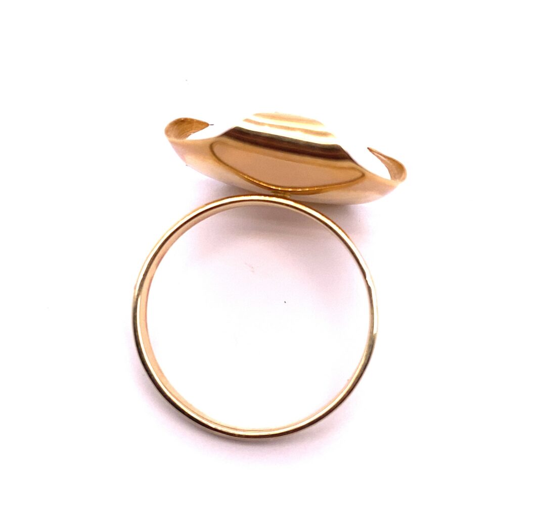 a gold ring with a shell on it