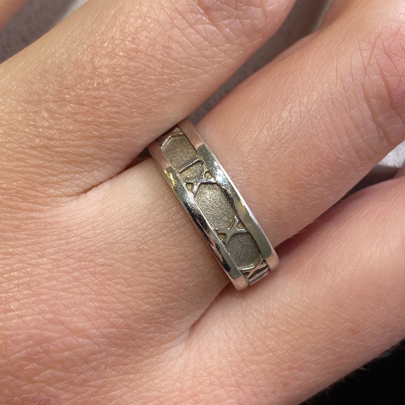 a woman's hand with a silver ring on it