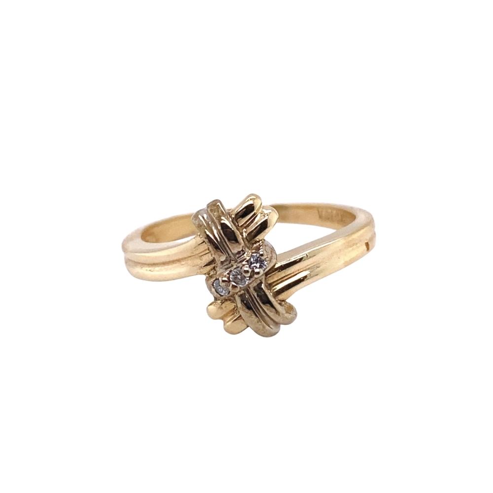 a yellow gold ring with two diamonds on it