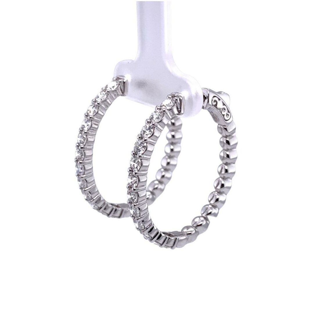 two silver hoop earrings on a white background