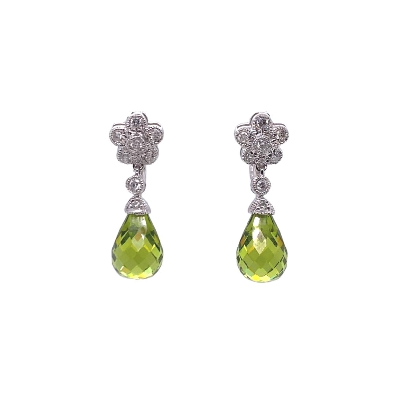 a pair of earrings with green and white stones