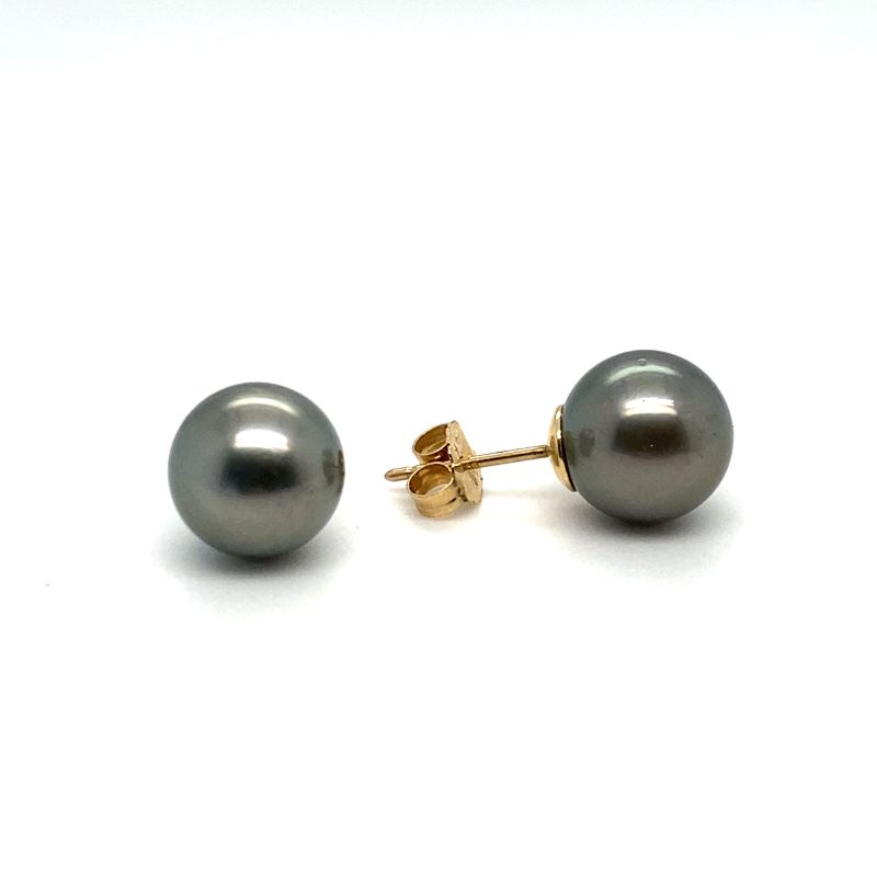a pair of black pearl earrings on a white background