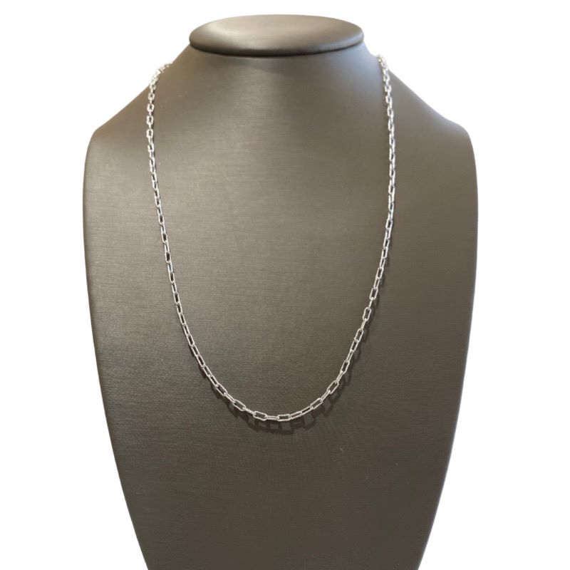 a silver necklace on a mannequin
