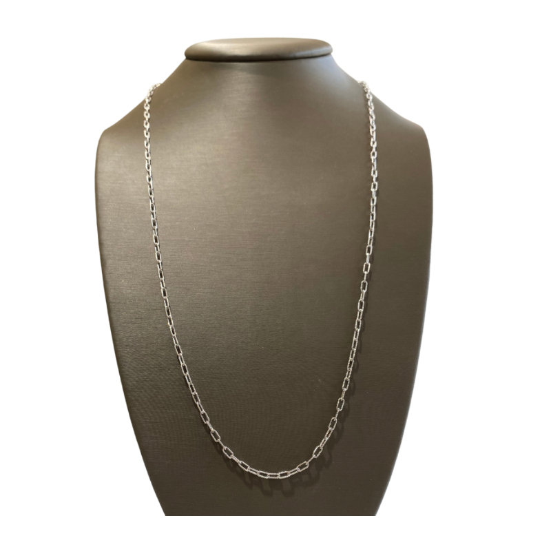 a silver necklace on a mannequin