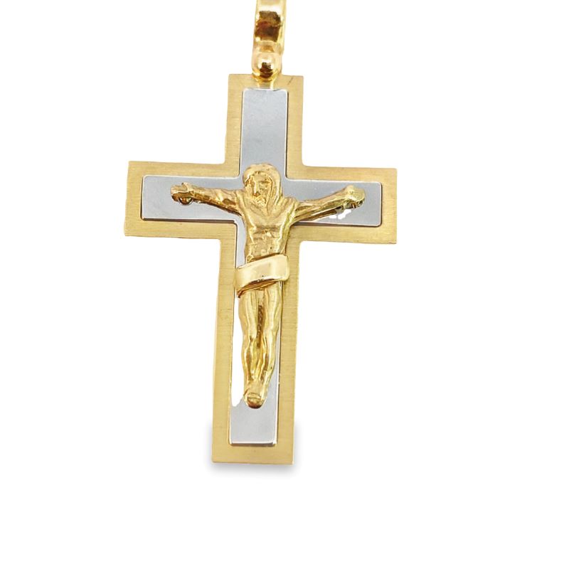 a gold and silver cross with jesus on it