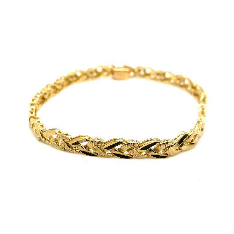 a yellow gold bracelet with an intricate design