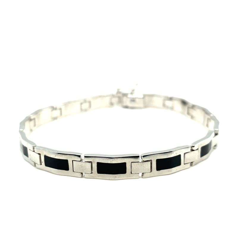 a black and white bracelet with squares on it