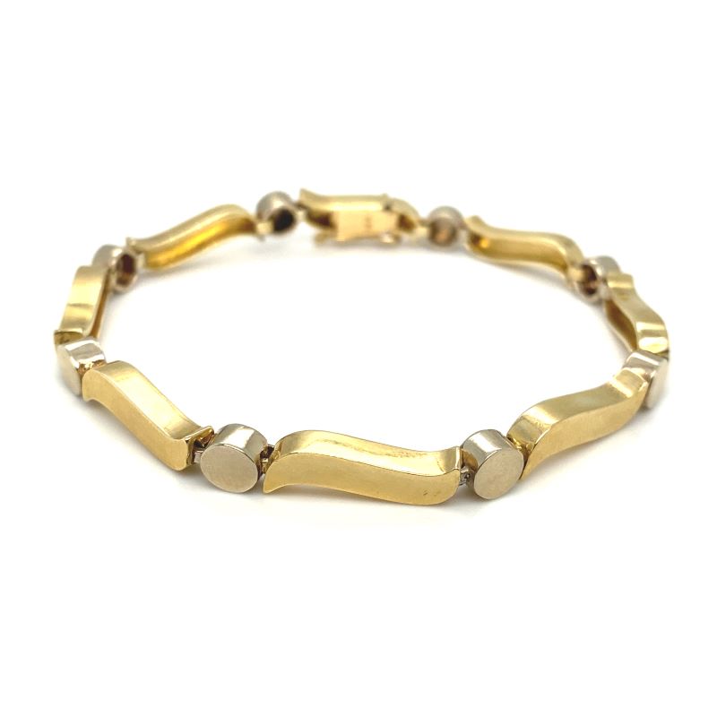 a gold bracelet with two circles on it