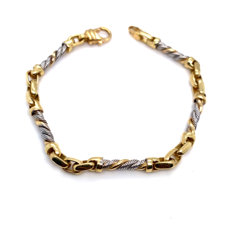 a gold and silver bracelet on a white background