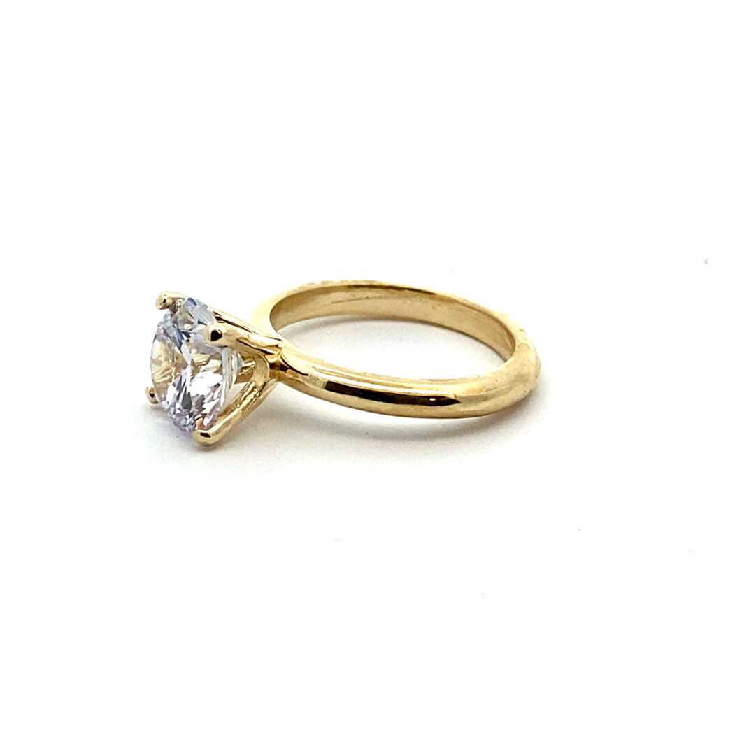 a yellow gold ring with a single diamond