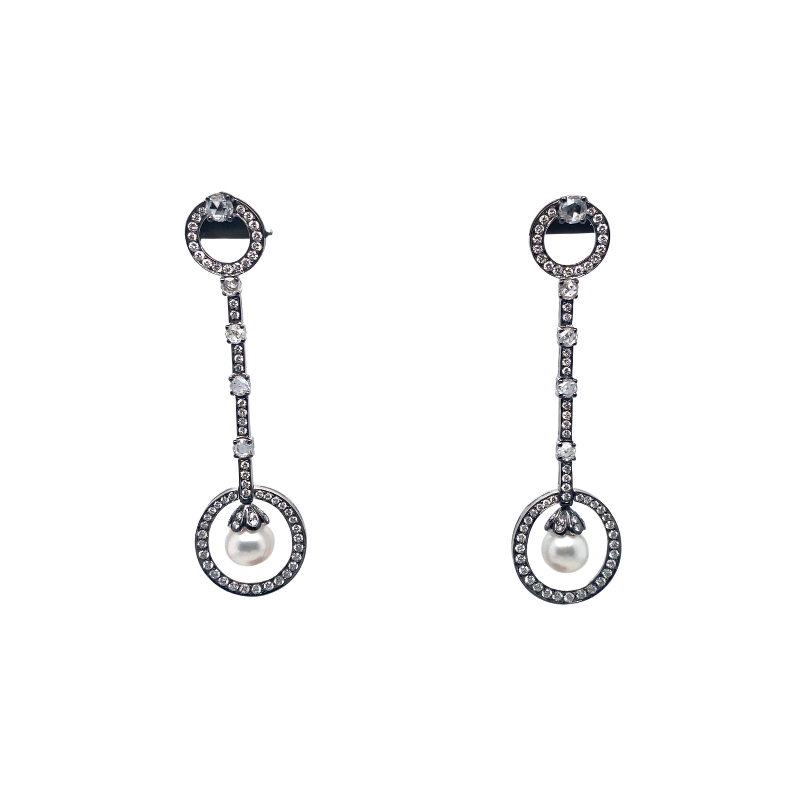 a pair of earrings with diamonds and pearls