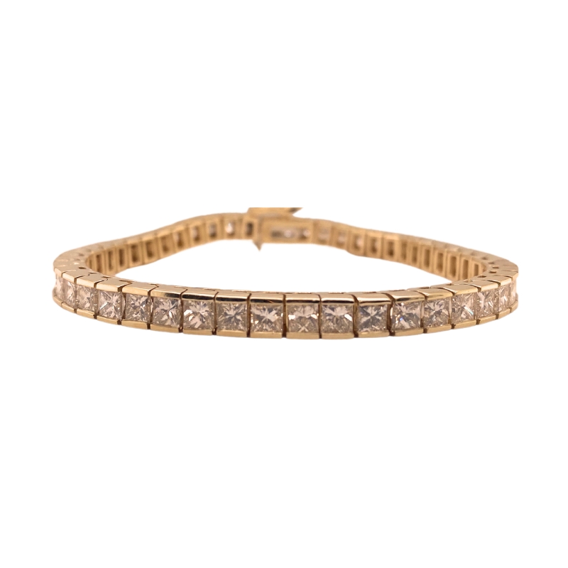 a gold bracelet with square cut stones