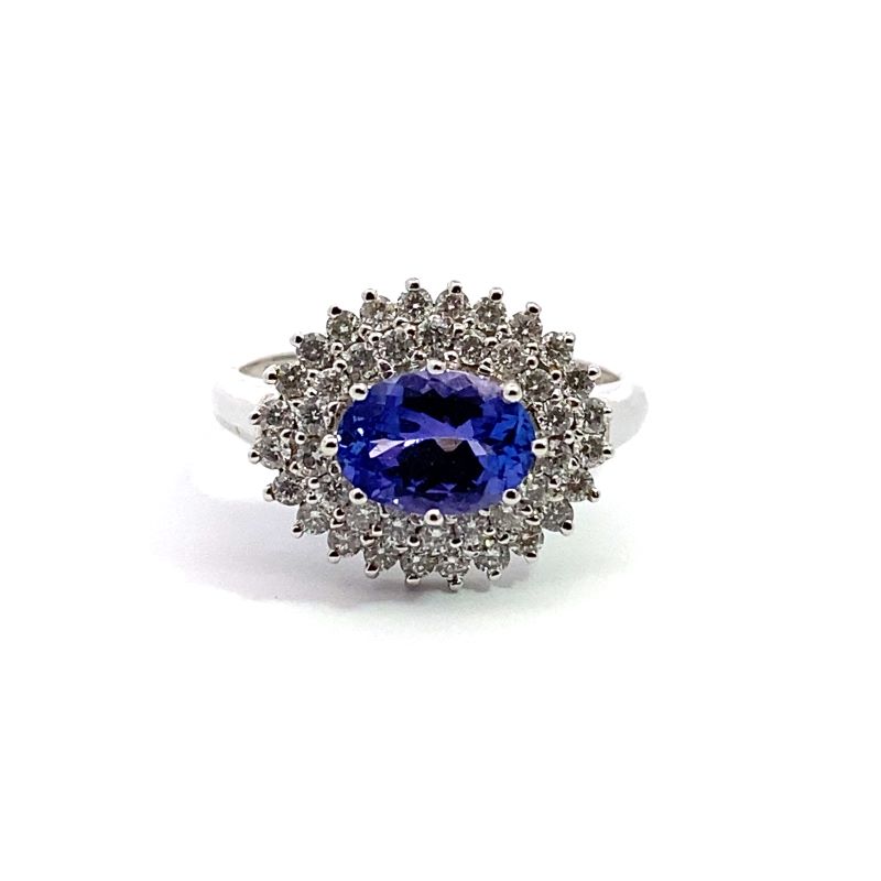 a tan and white ring with a blue stone