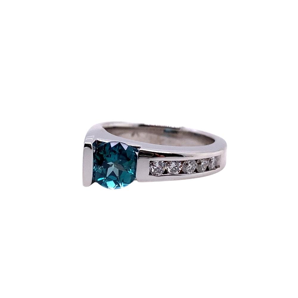 a ring with a blue stone and diamonds