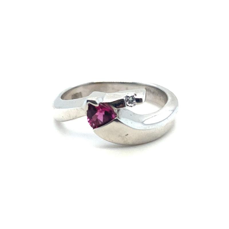 a silver ring with a pink stone in the middle