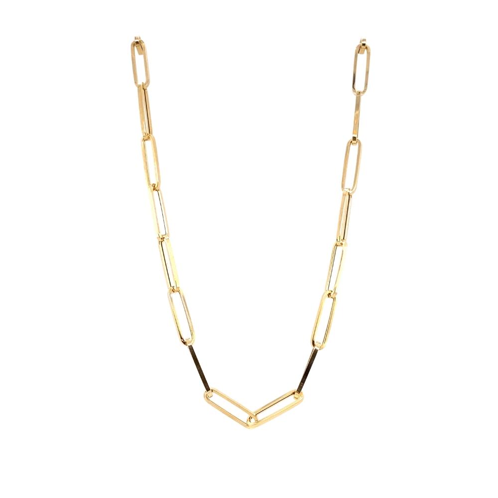 a gold chain necklace with black beads