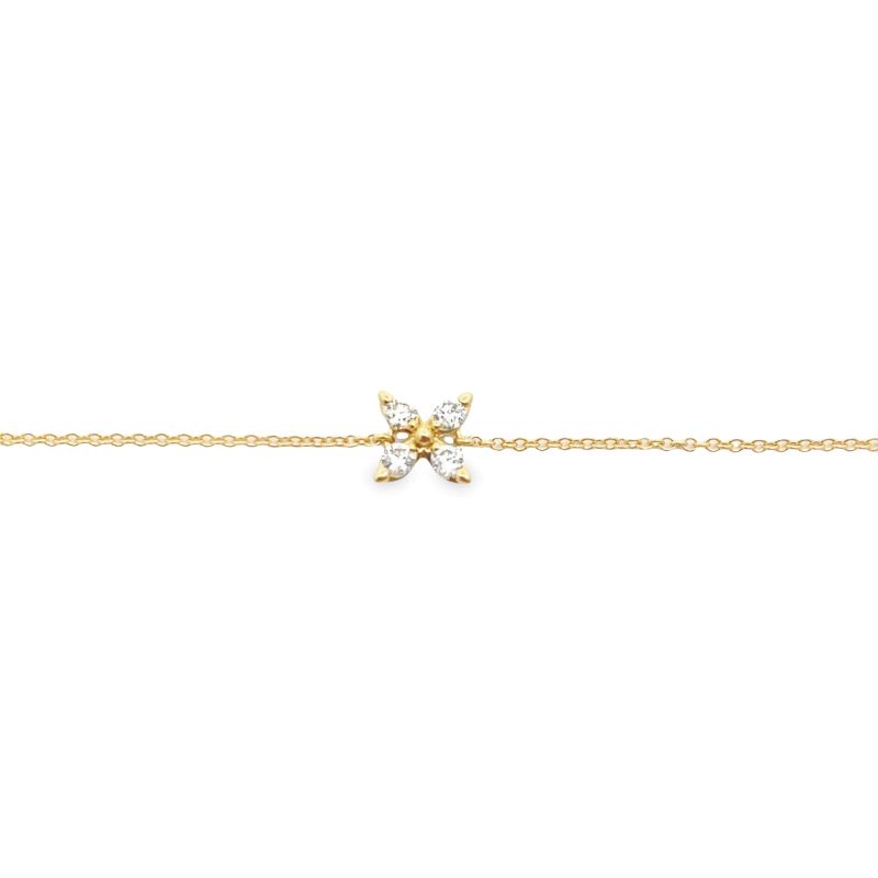 a gold bracelet with two small diamonds on it
