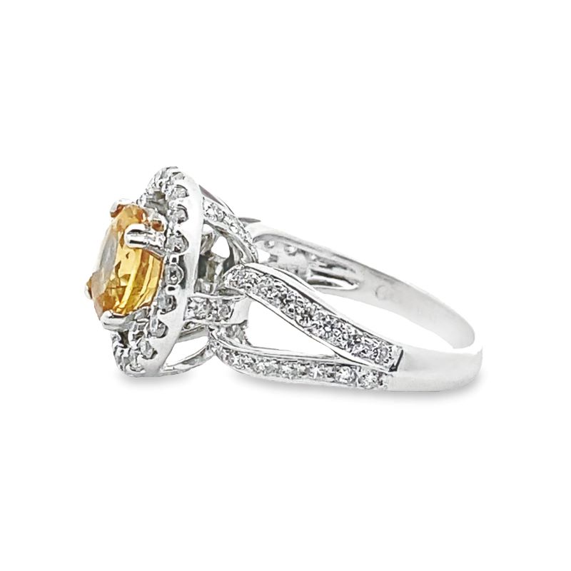 a yellow and white diamond ring on a white background