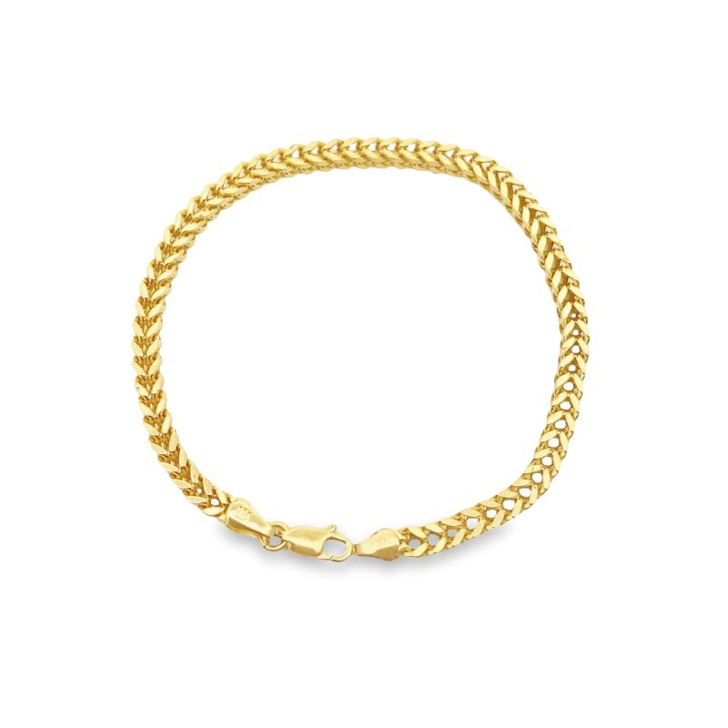 a yellow gold bracelet with a curb