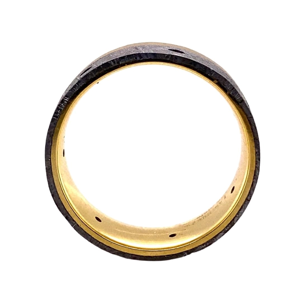 a gold and black wedding ring on a white background