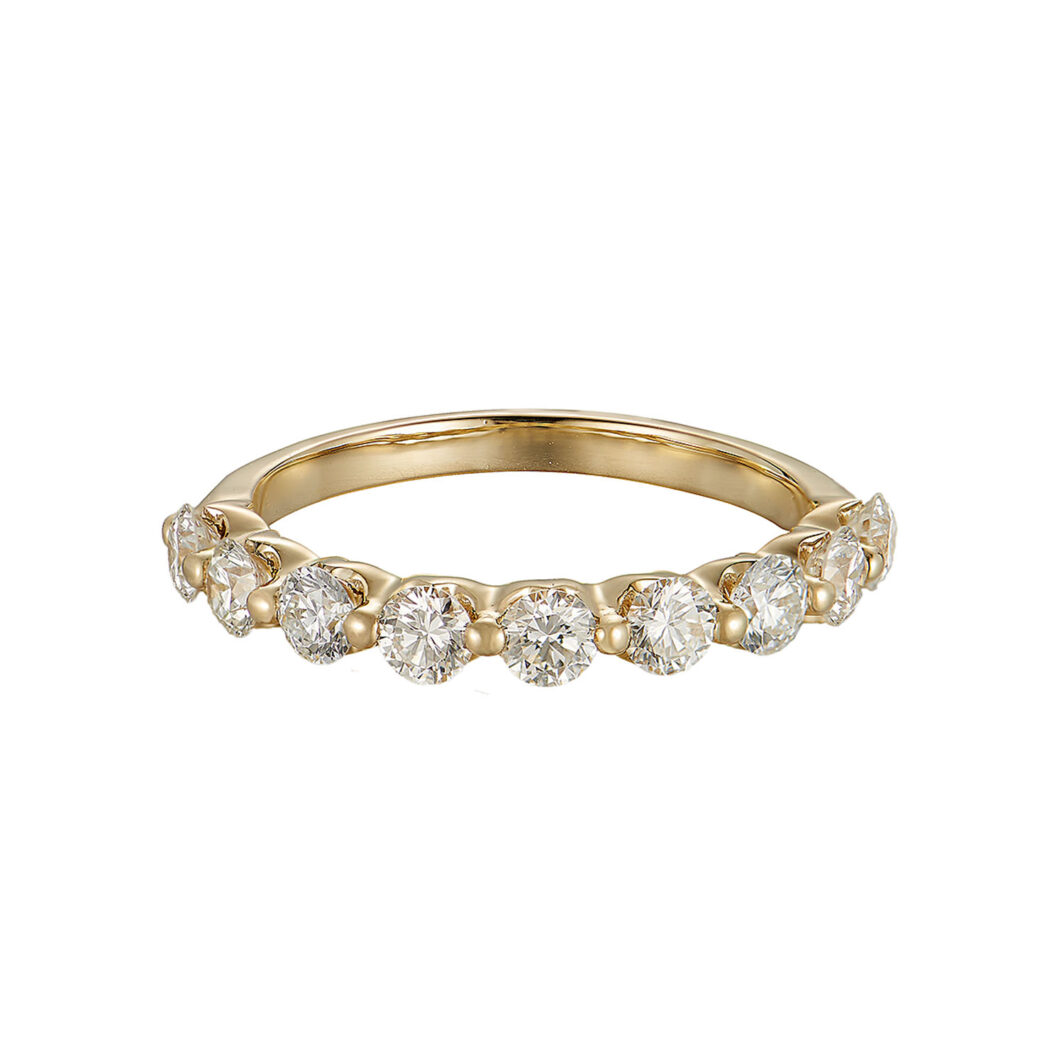 a yellow gold ring with five diamonds