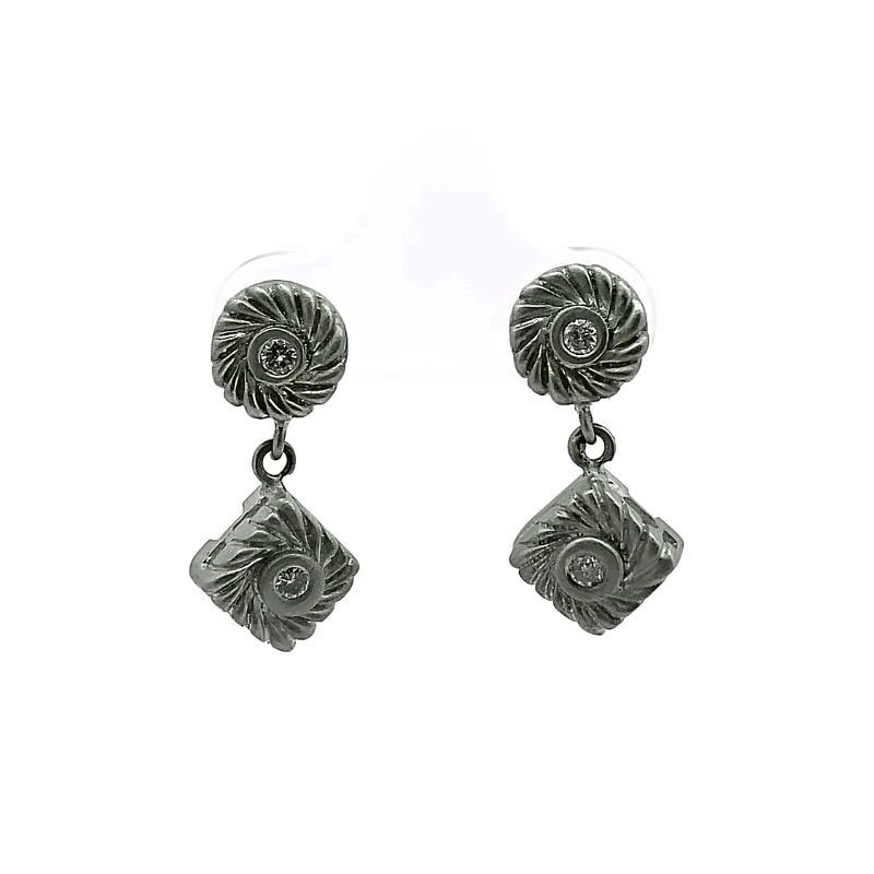 a pair of silver earrings on a white background