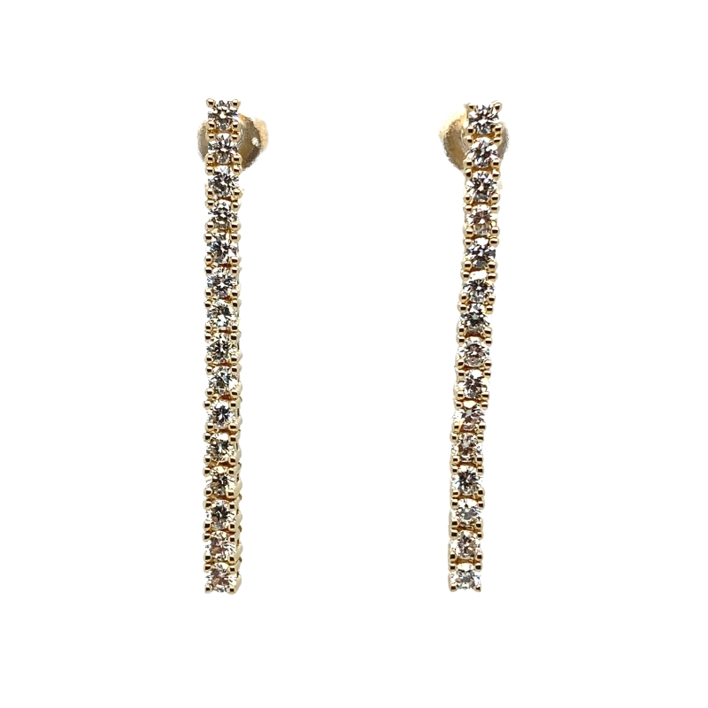 a pair of gold tone earrings with clear stones
