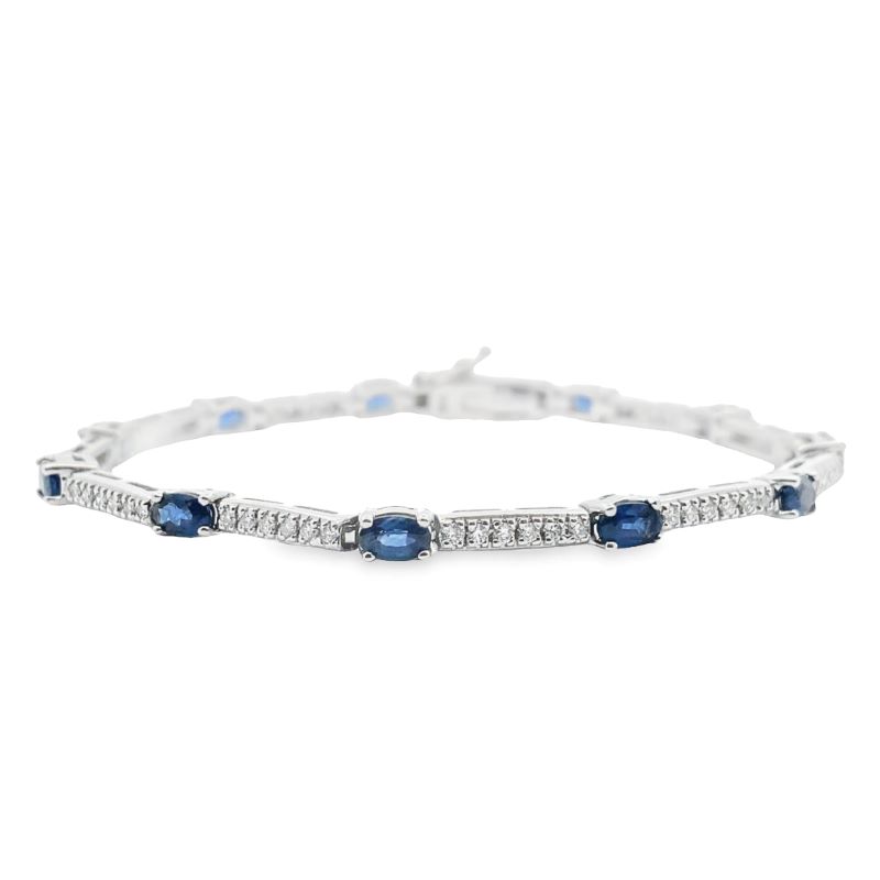 a white gold bracelet with blue stones and diamonds