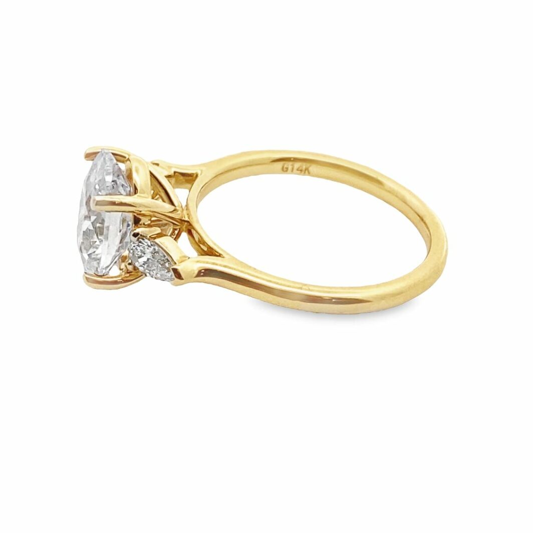 a yellow gold ring with two diamonds
