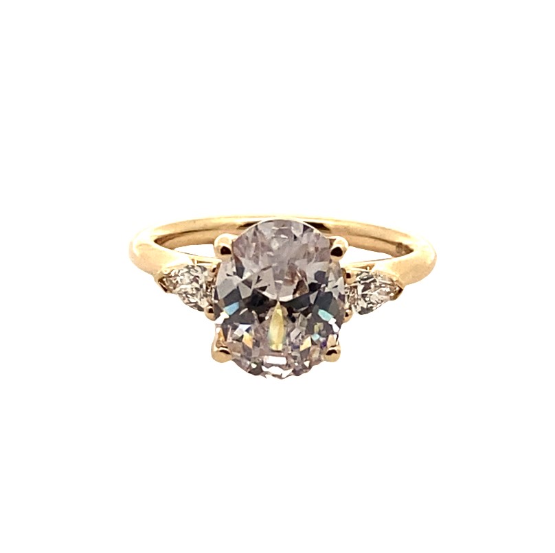 a ring with an oval shaped diamond and three smaller diamonds