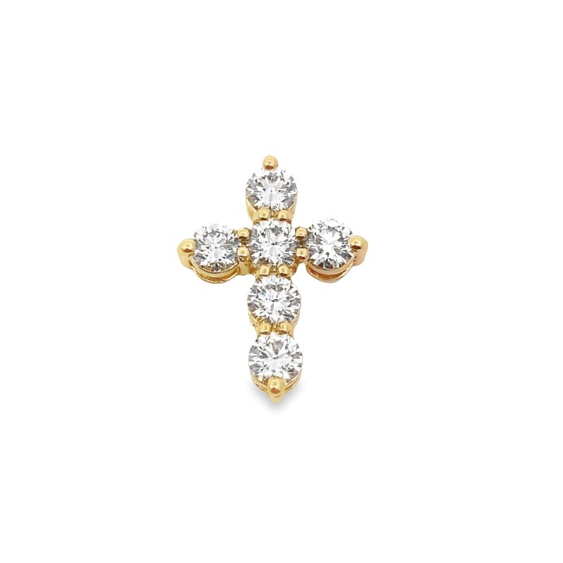 a gold cross with three stones on it