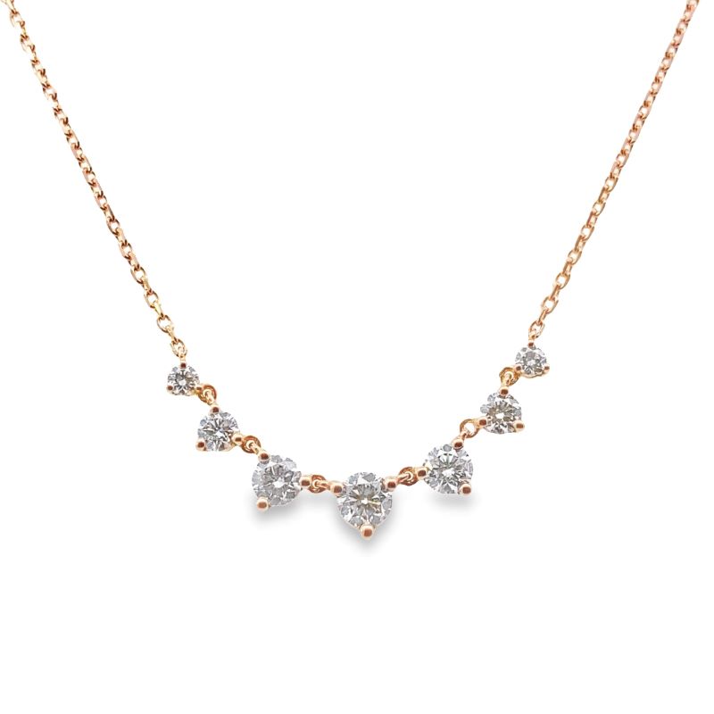 a gold necklace with three diamonds on it