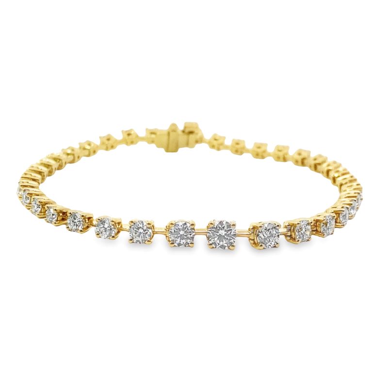 a yellow gold bracelet with three diamonds