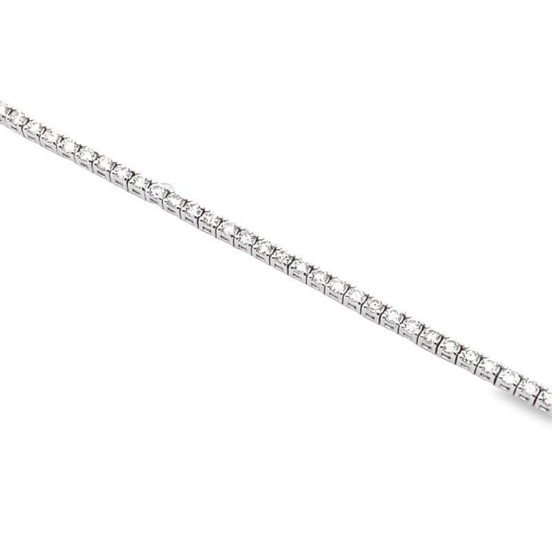 a diamond tennis bracelet on a white background