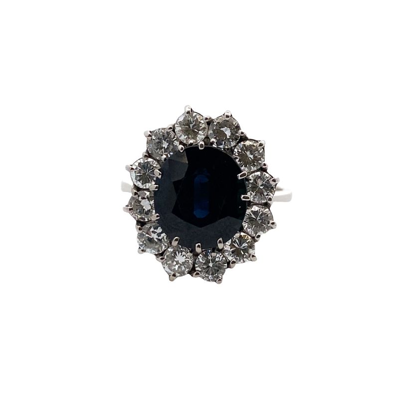 a ring with a blue stone surrounded by white diamonds