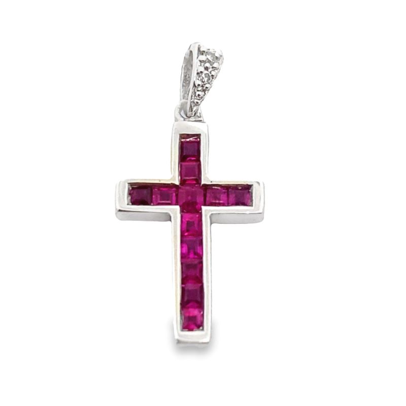 a cross pendant with a pink stone in the center