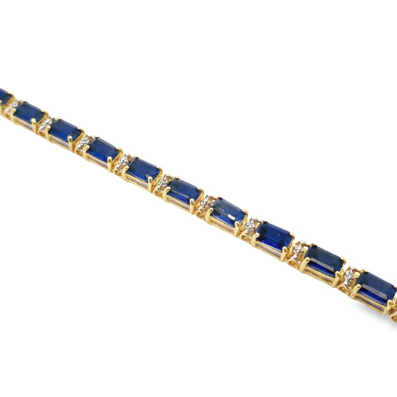a gold bracelet with blue stones and diamonds
