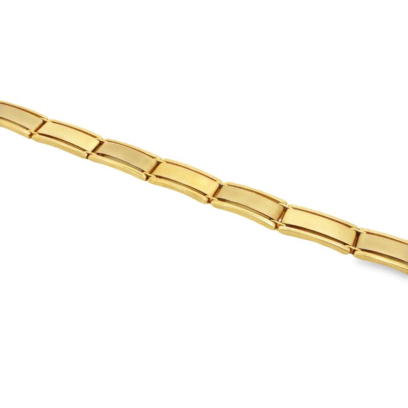 a gold bracelet on a white background