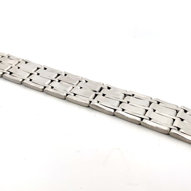 a silver watch bracelet on a white surface