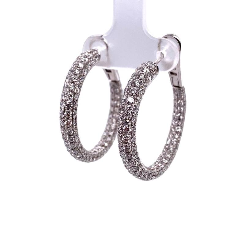 a pair of silver hoop earrings with diamonds