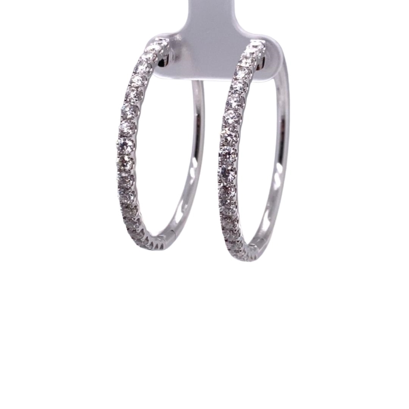 a pair of silver hoop earrings with diamonds
