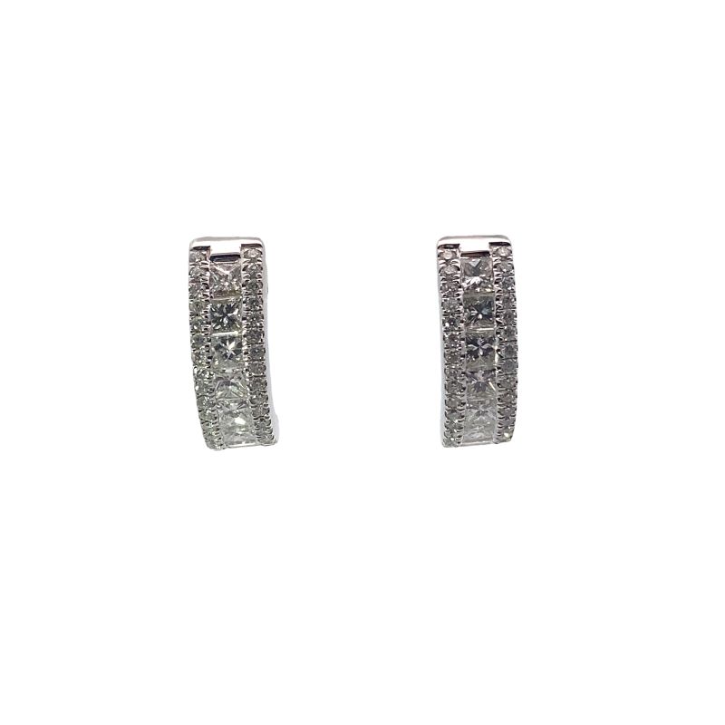 a pair of silver earrings with white diamonds