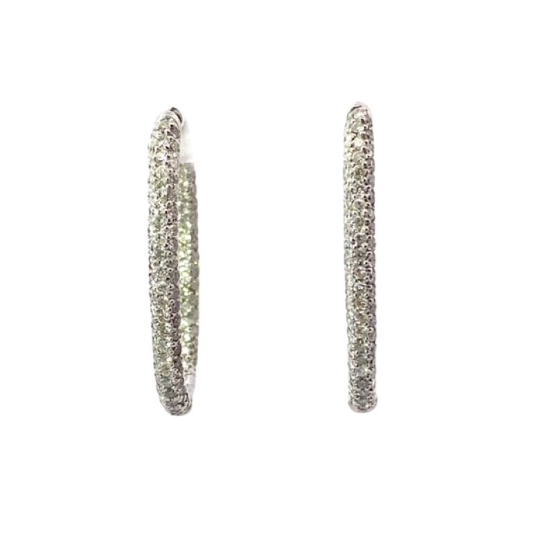 a pair of earrings with white stones