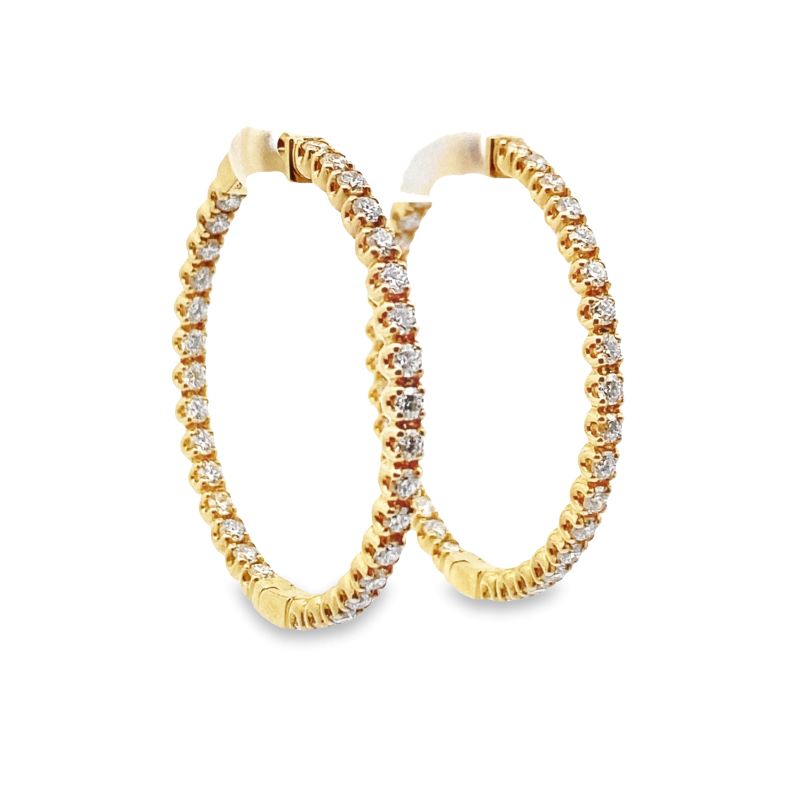 two gold hoop earrings with diamonds