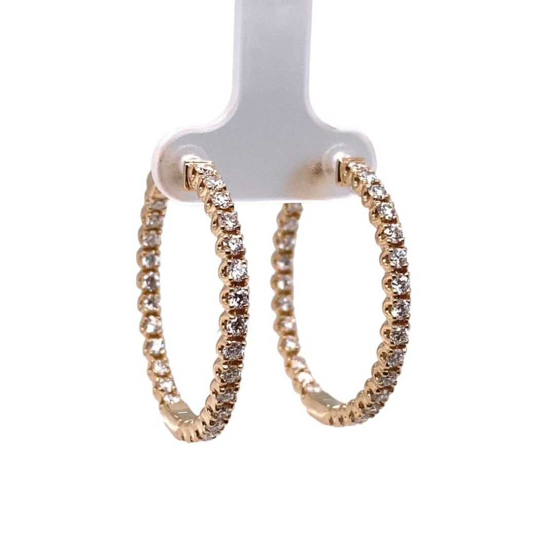 a pair of gold hoop earrings with diamonds
